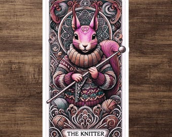 May include: A pink squirrel wearing a colorful knitted sweater and holding knitting needles. The image is framed with ornate details and the text "THE KNITTER" is at the bottom.
