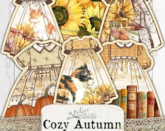 May include: Printable paper doll dress cutouts with an autumn theme. The dresses feature sunflowers, pumpkins, cats, music notes and books. The text "Cozy Autumn" is printed on a banner.