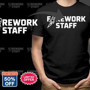 May include: A black short-sleeved t-shirt featuring the white text FOREWORK STAFF with a rocket ship graphic replacing the letter O. The design is printed on the chest area of the shirt, which is displayed against a dark background.