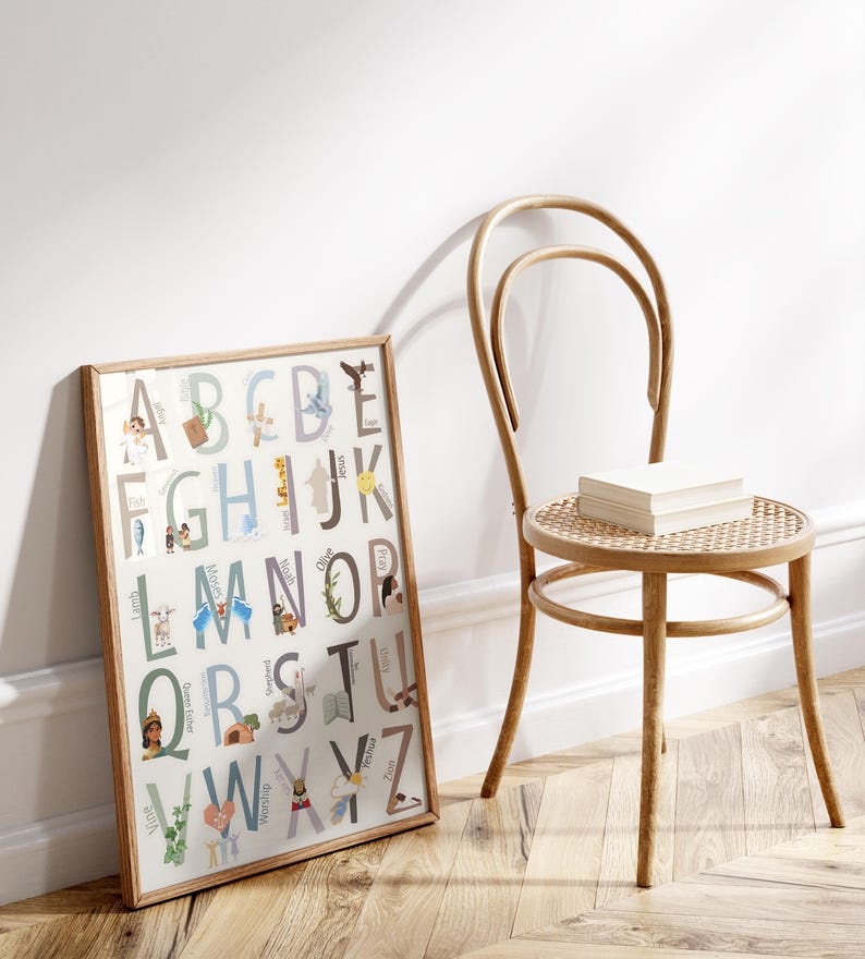 May include: A framed alphabet poster with illustrations for each letter. The poster has a white background with light blue, brown, and yellow accents. The letters are in a large, bold font. The illustrations are of various animals, objects, and people.