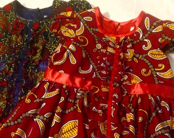 Red navy special occasion party dress celebration dress with ribbon and ruffle frill detail in African Ankara print