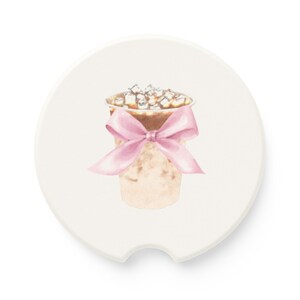 May include: A white ceramic coaster featuring a watercolour illustration of a coffee drink with marshmallows and a pink ribbon.