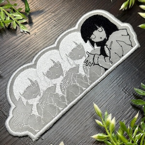 May include: Embroidered patch with an anime-style character in black and white, reaching out a hand. The design includes multiple faded character images within a grey cloud-shaped border. The patch is in shades of grey, black, and white.