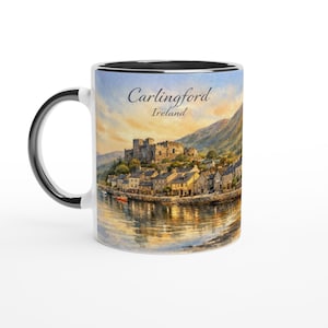 May include: White ceramic mug with a black interior and handle. The mug features a watercolor painting of Carlingford, Ireland, with a castle, town, and water reflection. The text "Carlingford Ireland" is printed on the mug.