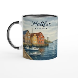 May include: A white ceramic mug with a black interior and handle. The mug features a watercolour painting of Halifax, Canada, with colourful buildings, boats, and a lighthouse. The text "Halifax CANADA" is displayed on the mug.