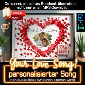 May include: A framed picture with a heart made of red paper hearts. The heart has a photo of a couple inside. The text "Für die Liebe meines Lebens!" is written on the picture. The text "Your Love Song!" is written below the picture. The text "personalisierter Song" is written below the text "Your Love Song!" The text "Individuelle Texte für deinen eigenen Song" is written below the text "personalisierter Song".