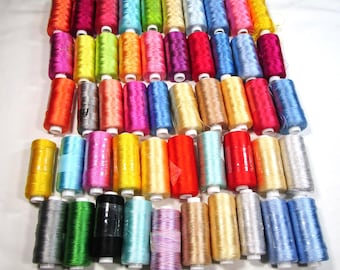 May include: A collection of numerous sewing thread spools in a wide variety of vibrant colors including red, blue, yellow, green, pink, orange, purple, silver, and black. Each spool features a cylindrical shape with white plastic ends.