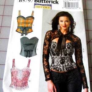 May include: A Butterick sewing pattern envelope featuring illustrations of bustiers and a woman wearing a lace top. The envelope has the text "B5797 Butterick" and "HISTORY". The bustiers are in various colors and styles.