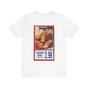 May include: White t-shirt with a red and blue graphic of a Kirkland Signature Chicken Bake for $2.99. The graphic shows a close-up of the chicken bake with a cheesy filling.