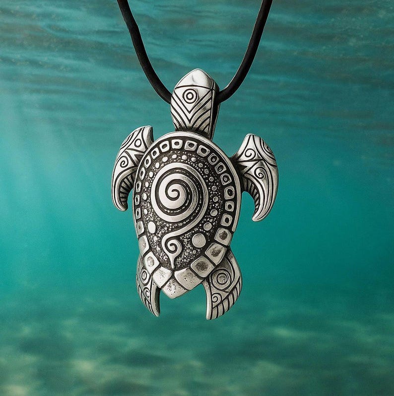 May include: Silver turtle pendant with detailed spiral and dot patterns, suspended from a black cord. The pendant's shell features a prominent spiral design, and the flippers have decorative patterns. The pendant is a detailed piece of jewellery.