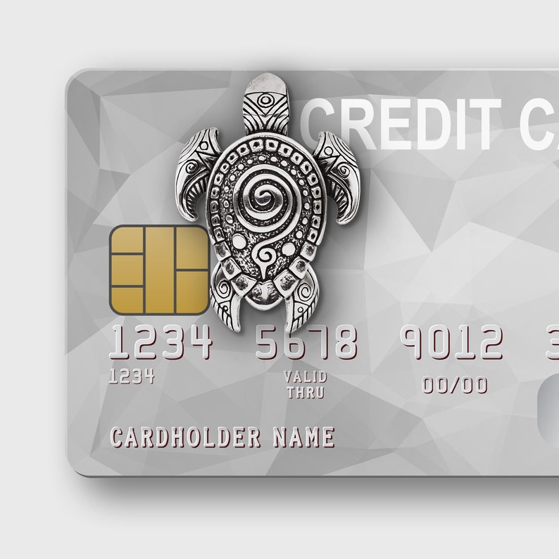 May include: A silver turtle charm sits on a credit card with a geometric design. The card displays the words "CREDIT CARD". The card number is 1234 5678 9012 3456.