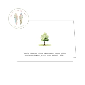 May include: A white greeting card featuring a watercolor illustration of a small tree with green leaves and a brown trunk. The card includes the text "He is like a tree planted by streams of water..." and the artist's logo.