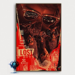 May include: A vintage-style movie poster for the film "The Lost Boys". The poster features a red and black color scheme with a ripped and torn design. The title of the film is in large, white letters. The poster also features a tagline: "Being wild is their blood."