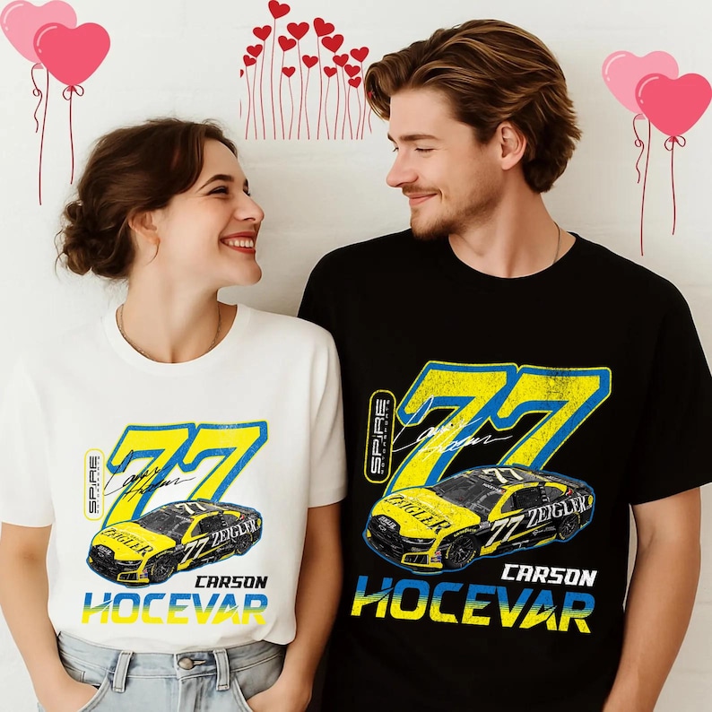 May include: A white and black t-shirt featuring a yellow and blue graphic of a race car with the number 77. The text "Carson Hocevar" is below the car. The shirts are worn by a couple.