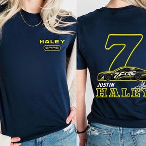 May include: A navy blue t-shirt with the name "HALEY" printed on the front and a racing car design with the number "7" and the name "JUSTIN HALEY" printed on the back.
