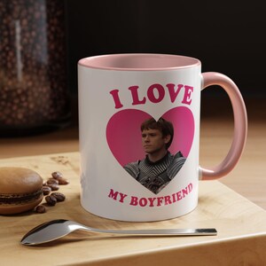 May include: White ceramic mug with a pink interior and handle. The mug features the text "I LOVE MY BOYFRIEND" in pink, with a pink heart containing a photo of a man.
