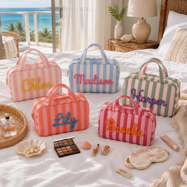 May include: Five rectangular striped cosmetic bags with top handles and personalized names in cursive script. The bags feature vertical stripes in pink, blue, orange, green, and red, with names Chloe, Madison, Harper, Lily, and Brooke in raised lettering.