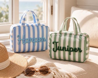 May include: Two rectangular zippered travel bags with top handles. One bag features blue and white vertical stripes with the name Harper in blue script. The other bag features green and white vertical stripes with the name Juniper in green script.
