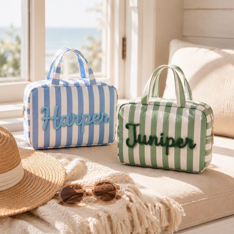 May include: Two rectangular zippered travel bags with top handles. One bag features blue and white vertical stripes with the name Harper in blue script. The other bag features green and white vertical stripes with the name Juniper in green script.