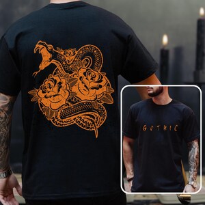 May include: Black t-shirt with an orange design of a snake and roses on the back. The inset image shows the front of the shirt with the word "GOTHIC" in orange.