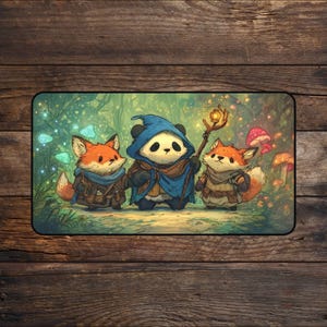 May include: A rectangular mousepad with a fantasy illustration of a panda and two foxes in a forest. The panda wears a blue wizard's hat and cloak, holding a glowing staff. The foxes are dressed in adventurer's attire.