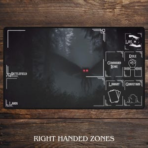 May include: A black playmat featuring a dark forest scene with a large moth-like creature with glowing red eyes. White text indicates zones for gameplay, including "Battlefield" and "Lands". The phrase "Right Handed Zones" is at the bottom.