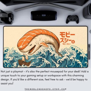 May include: A rectangular playmat featuring a whimsical design of a sushi-whale in a sea of waves. The sushi-whale has orange and white coloring. Japanese text is visible. The playmat is designed for gaming or workspace use.