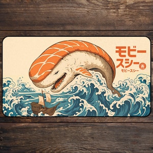 Dive into a mythical sushi world as Moby Sushi rises from the waves. This creative fusion of the classic maritime legend and sushi art features the great whale, covered in a slice of salmon, majestically gliding through the ocean. The Japanese text モビースシー (Moby Sushi) adds a bold and authentic touch to this imaginative design.