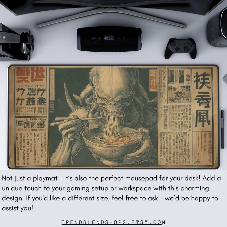May include: A rectangular playmat with a vintage-style illustration of a creature eating noodles, with Japanese text. The playmat is designed for gaming setups and workspaces. The image has a beige and brown color scheme.