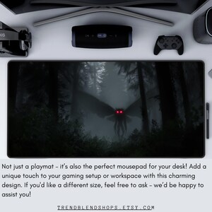 May include: Black rectangular mousepad featuring a dark forest scene with a winged creature with glowing red eyes. The text on the mousepad reads "TRENDBLENDSHOPS.ETSY.COM".