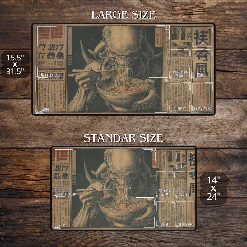 May include: A rectangular playmat with an illustration of a creature eating noodles. Available in two sizes: 39.4 cm x 80 cm and 35.6 cm x 61 cm. The design incorporates Japanese text and zones for a card game, labeled 'Battlefield' and 'Graveyard'.