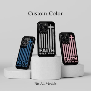 May include: Three phone cases with a patriotic design. Each case features a cross and vertical stripes, with the text "FAITH OVER FEAR." One case is blue, one is black and white, and one is pink. The words "Custom Color" and "Fits All Models" are also visible.