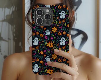 May include: A black phone case with a colorful floral pattern and white ghost silhouettes. The case has a camera lens cutout and a raised lip around the edges.