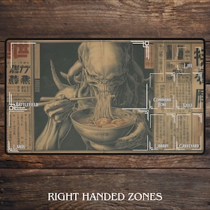 May include: A beige playmat with a detailed illustration of a creature eating noodles with chopsticks. The mat has zones labelled "Battlefield", "Lands", "Command Zone", "Life", "Exile", "Library", and "Graveyard". The text "Right Handed Zones" is at the bottom.