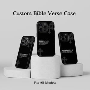 May include: Black phone cases with Bible verses printed in white. The cases feature verses from Isaiah 41:10, Philippians 4:13, and 2 Corinthians 12:9. Each case has a cross design. The text "Custom Bible Verse Case" is at the top, and "Fits All Models" is at the bottom.