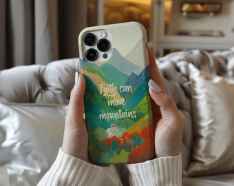 May include: A phone case featuring a colorful mountain landscape design with the text "Faith can move mountains." The case has a cream-colored border and a vibrant illustration of green, blue, and orange hues, with a small house in the center.