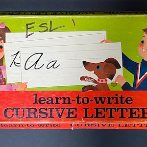 May include: Vintage Milton Bradley "Learn-to-Write Cursive Letters" box. The box features illustrations of children and a dog holding practice cards. The box is red, green, and white, with the text "ESL" on the top.