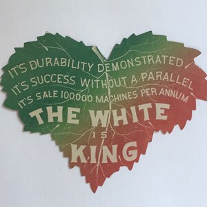 May include: A green, red, and white heart-shaped leaf with the text "IT'S DURABILITY DEMONSTRATED", "IT'S SUCCESS WITHOUT A PARALLEL", "IT'S SALE 100,000 MACHINES PER ANNUM", "THE WHITE IS KING".