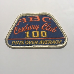 May include: A blue and white embroidered patch with the text "ABC Century Club 100 Pins Over Average".