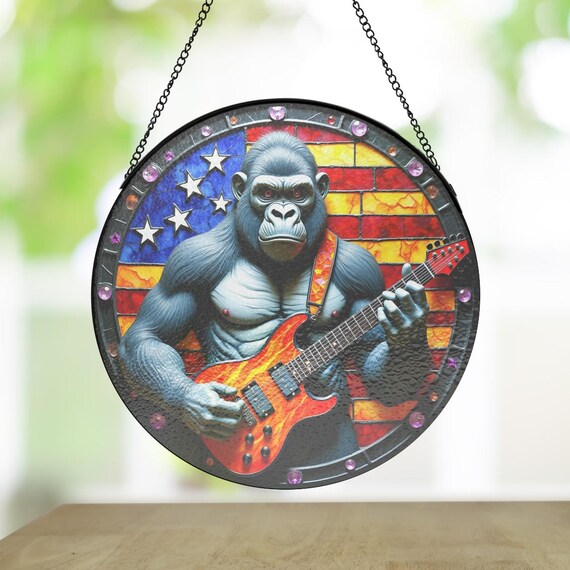 A patriotic gorilla suncatcher built in a 'rock storm' style — absurdist Americana kitsch that would genuinely confuse and delight anyone who saw it hanging in a window.