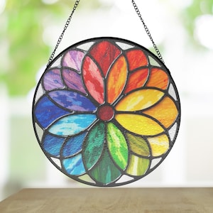 May include: A round stained glass window hanging with a chain. The window features a colorful flower design with petals in shades of red, orange, yellow, green, blue, and purple.