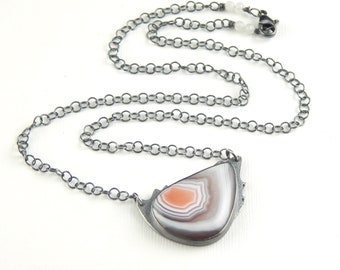 Banded Botswana agate necklace, beautiful bezel-set stone with purple, pink, & white, sterling silver metalwork necklace.