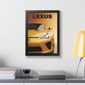May include: Framed print featuring a yellow Lexus sports car. The car is centered in the frame, with the word "LEXUS" in black block letters at the top. The background is a gradient of orange and yellow.