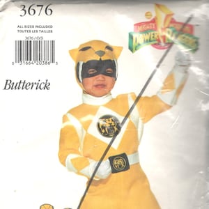 May include: A sewing pattern for a yellow Power Rangers costume. The pattern includes instructions for making a yellow jumpsuit with a tiger head design on the chest and a matching headpiece. The pattern is for a child's size and includes the text "Mighty Morphin Power Rangers" and "Trini-Yellow Ranger".