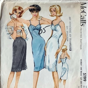 May include: Vintage McCall's sewing pattern for a slip or petticoat. The pattern is for sizes 12-32 and has a bust measurement of 81 cm. The pattern is printed on white paper with a blue and white illustration of three women wearing slips.