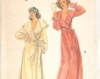May include: Vintage sewing pattern for a long, wrap-style robe with a ruffled collar. The pattern is for size medium and is from Butterick pattern number 5713. The pattern is priced at $1.75.