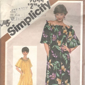 May include: Simplicity sewing pattern number 9844 for a dress with a ruffled neckline and short sleeves. The pattern includes two views: a yellow dress and a black dress with a floral print. The pattern is for petite sizes 6-8.