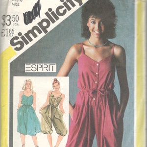 May include: Simplicity sewing pattern number 5590 for a jumpsuit with a button front and a tie at the waist. The pattern includes three different styles: a short jumpsuit, a long jumpsuit, and a dress. The pattern is for size 6 miss.