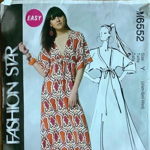 May include: A sewing pattern for a maxi dress with a V-neckline and a tie at the waist. The pattern is for sizes X-Small, Small, and Medium. The pattern is called "Fashion Star" and the pattern number is M6552.