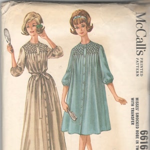 May include: A sewing pattern for a smocked robe in two lengths. The pattern is for misses' sizes 10-19 and includes a transfer. The pattern is printed on a white background with a blue and white illustration of two women wearing the robe.